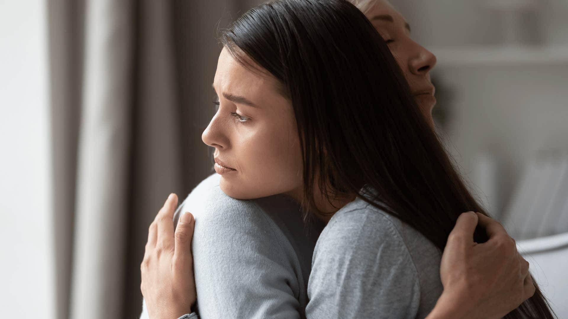 older daughter hugging mother