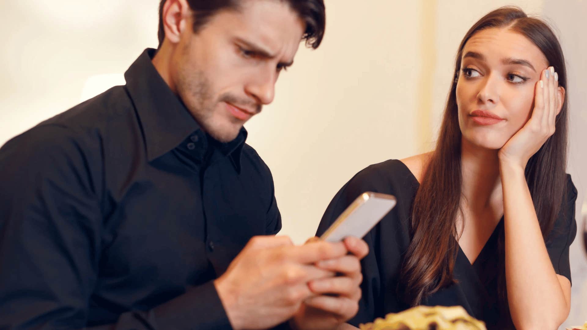 Woman staring at a man with a plate of food in front of her