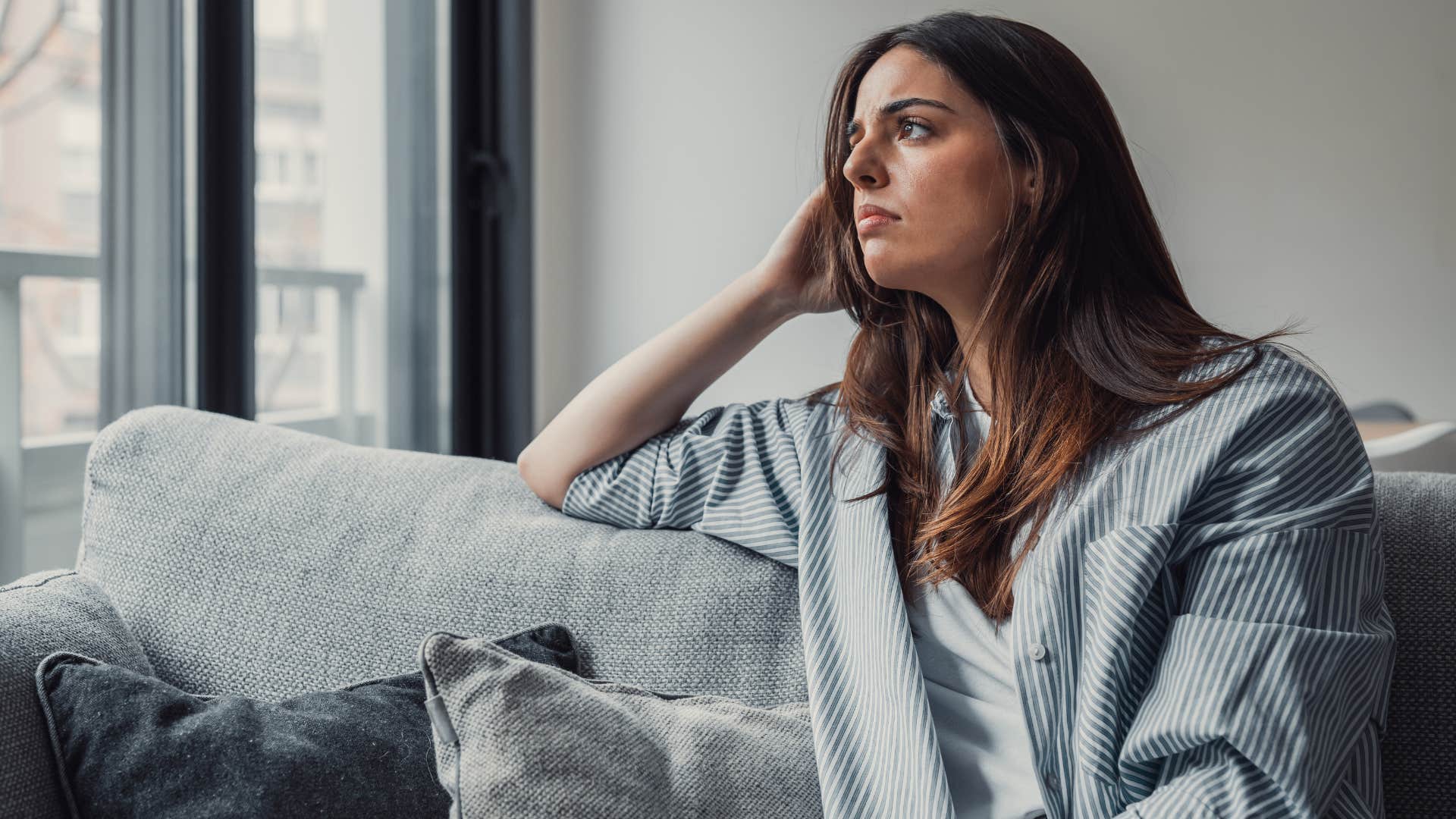 Sad woman staring out a window.