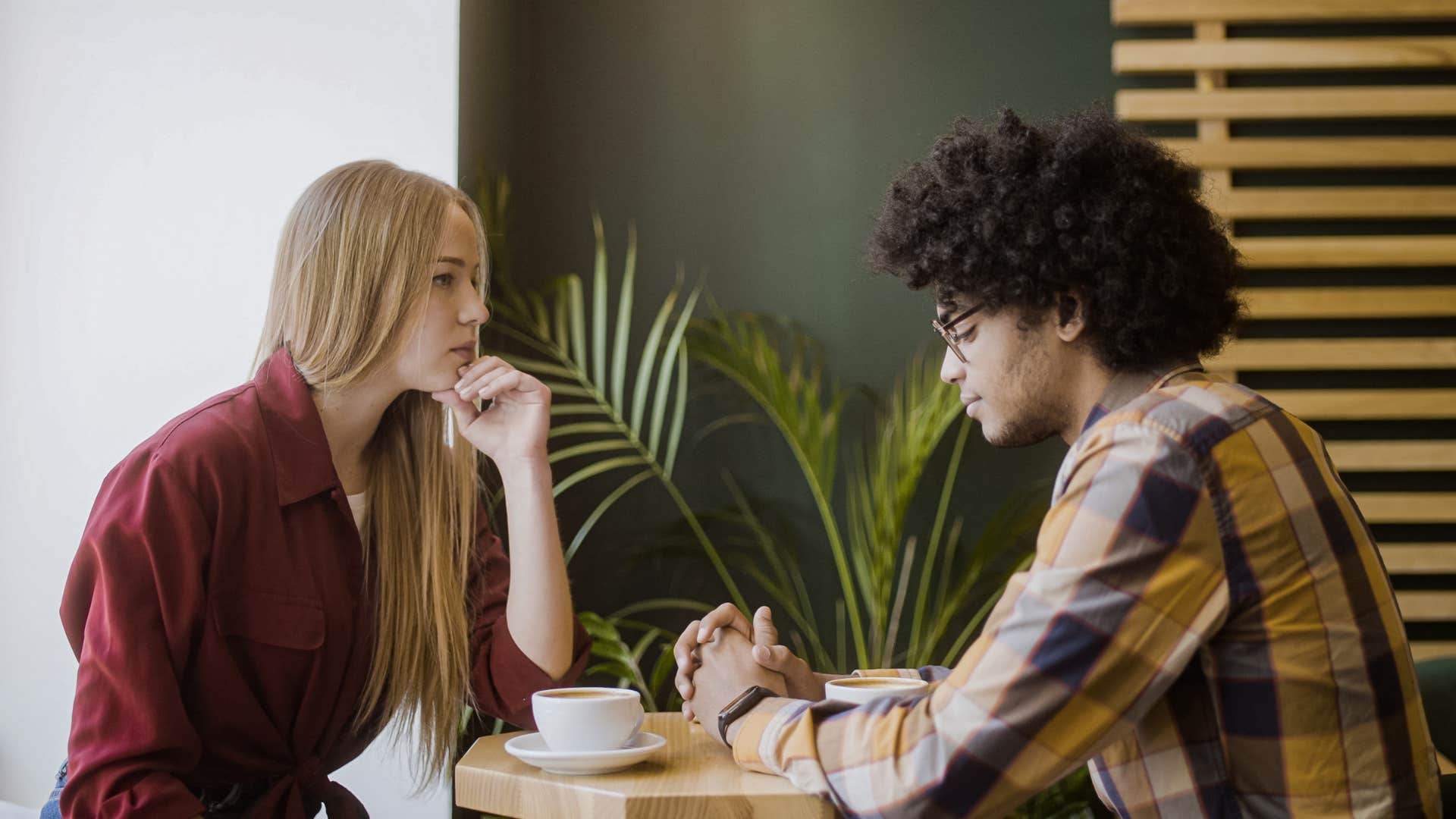 Couple having a serious conversation in a coffee shop.