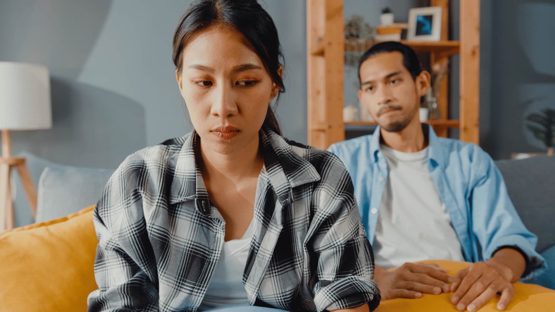 tense couple sitting on couch