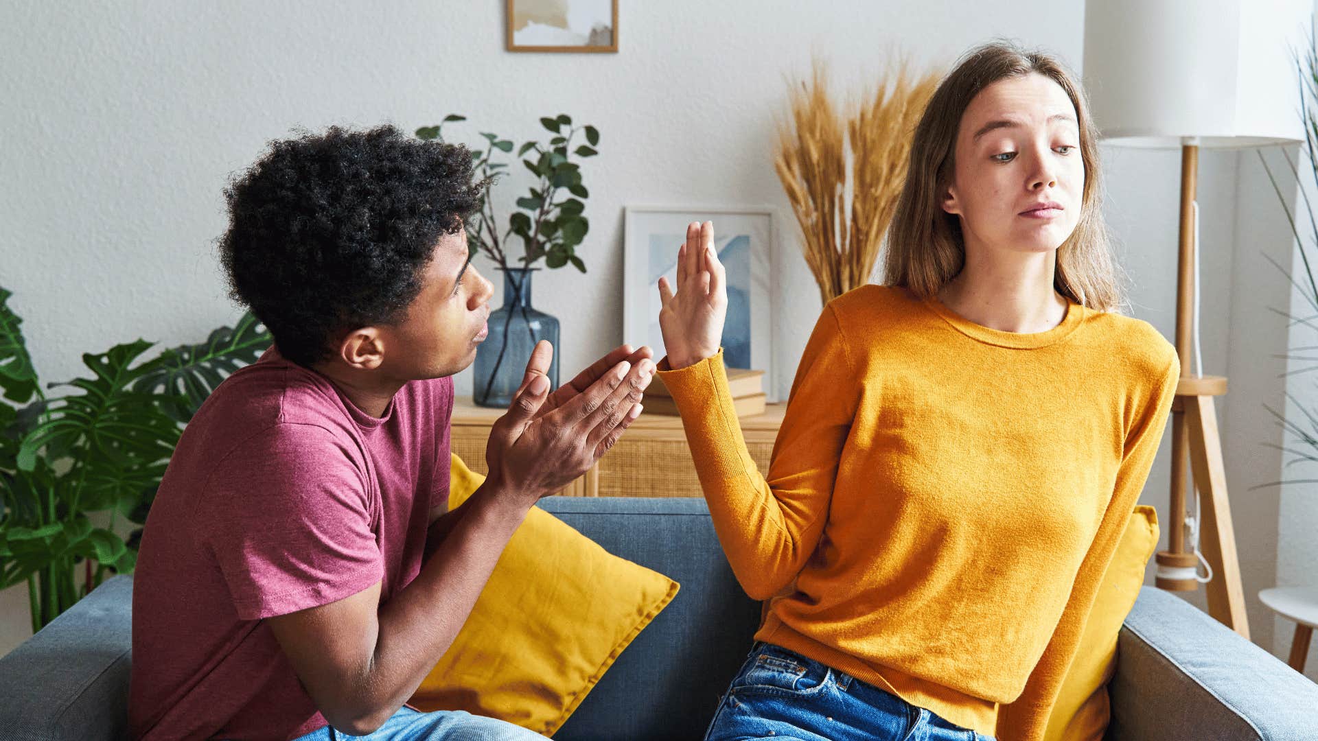 woman holding up hand and ignoring pleading man