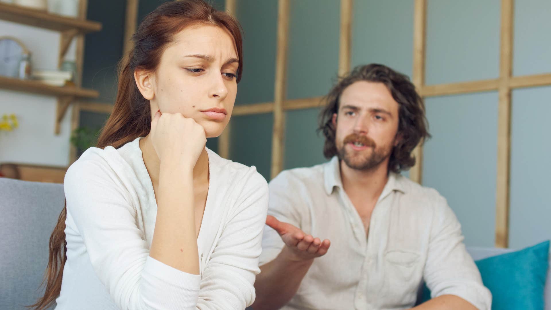 Woman ignoring her boyfriend while he's talking.