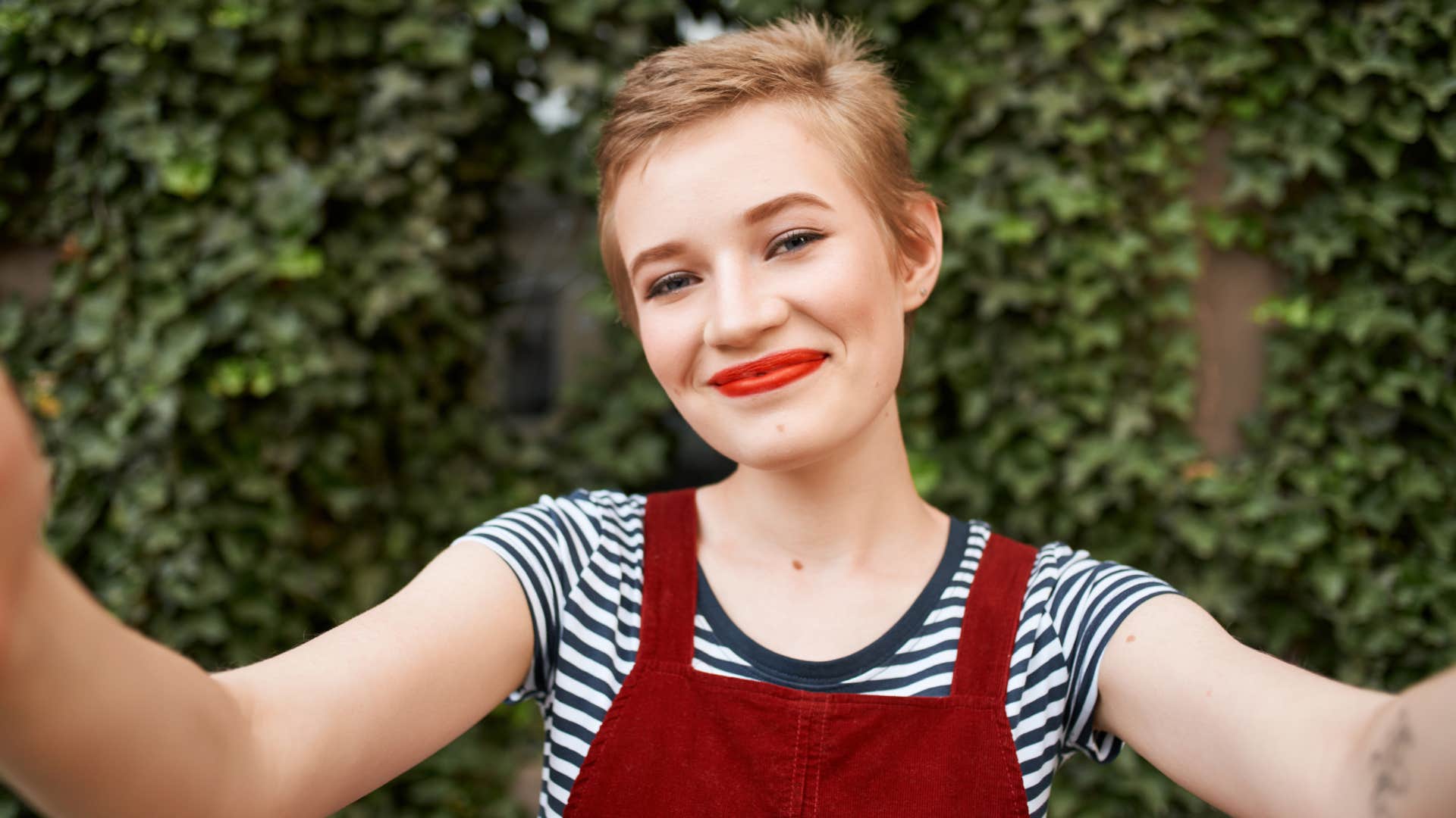 Woman with short hair smiling at the camera.