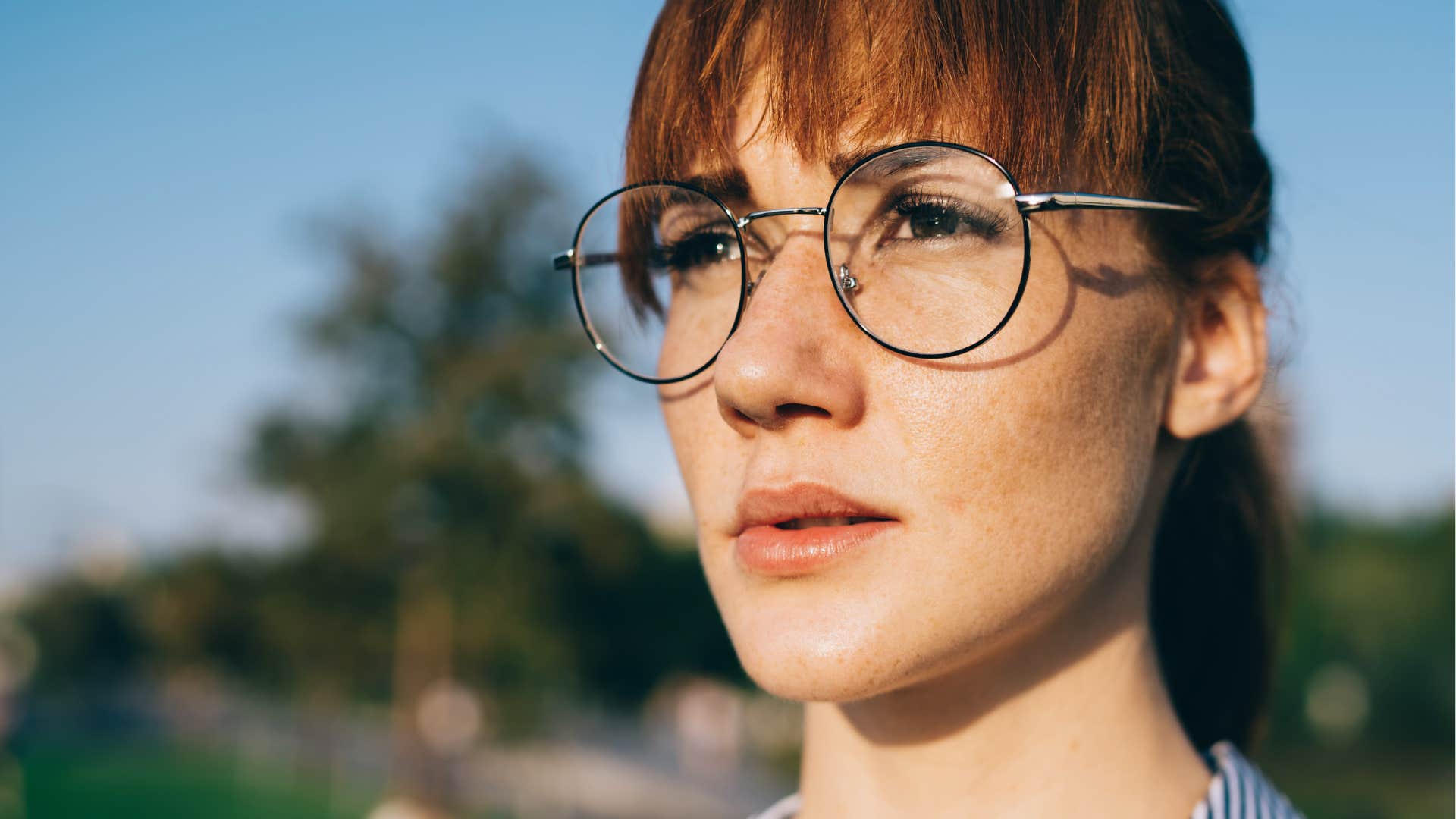 Woman looking serious and starting away from the camera.