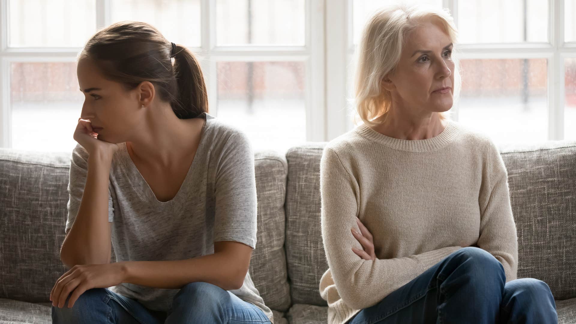 Woman and her adult daughter turned away from each other.