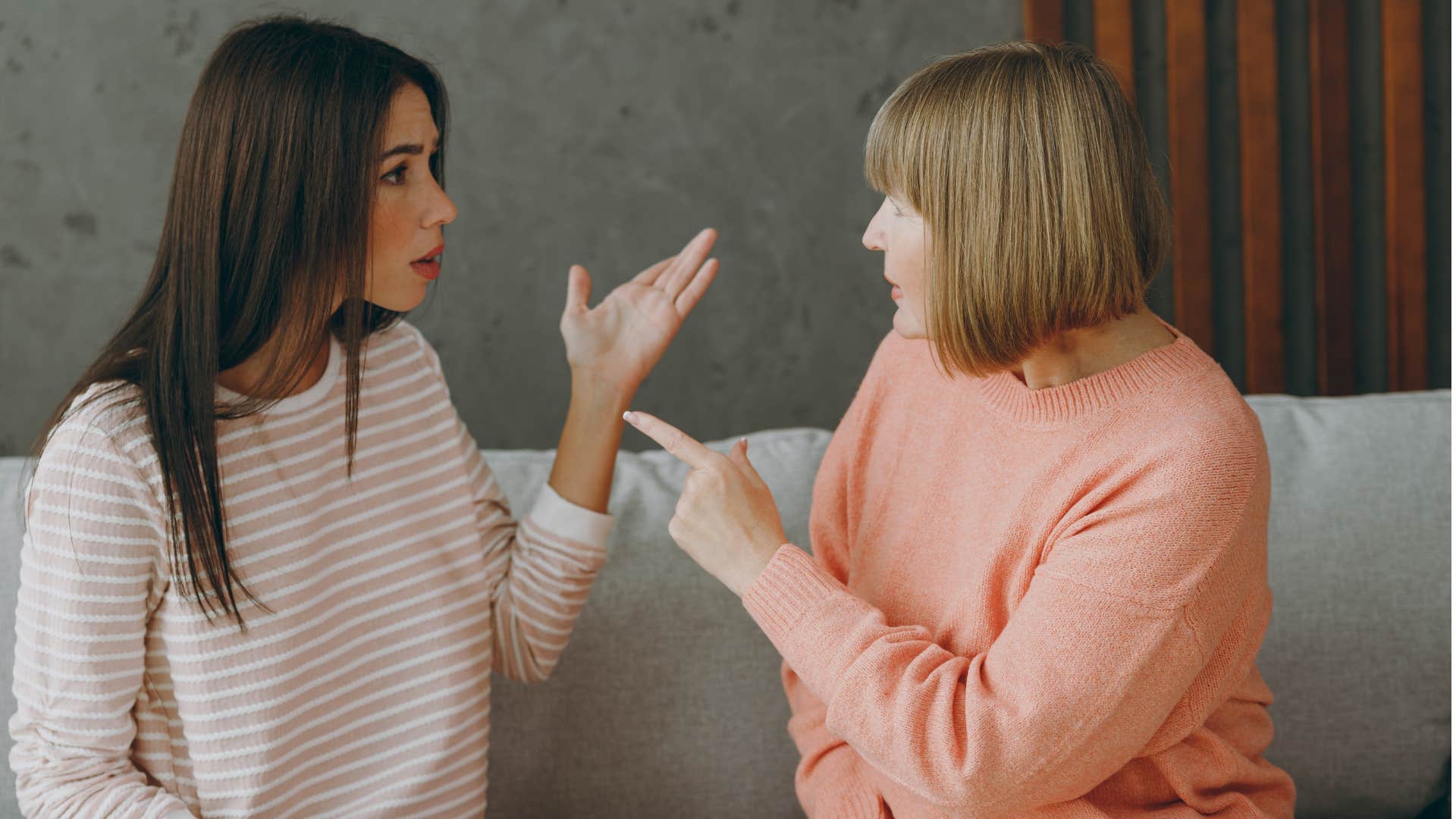 Adult daughter arguing on the couch with her mom.