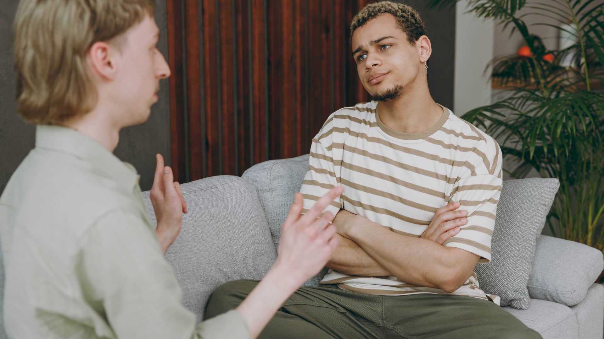 Man looking annoyed while his partner speaks to him.