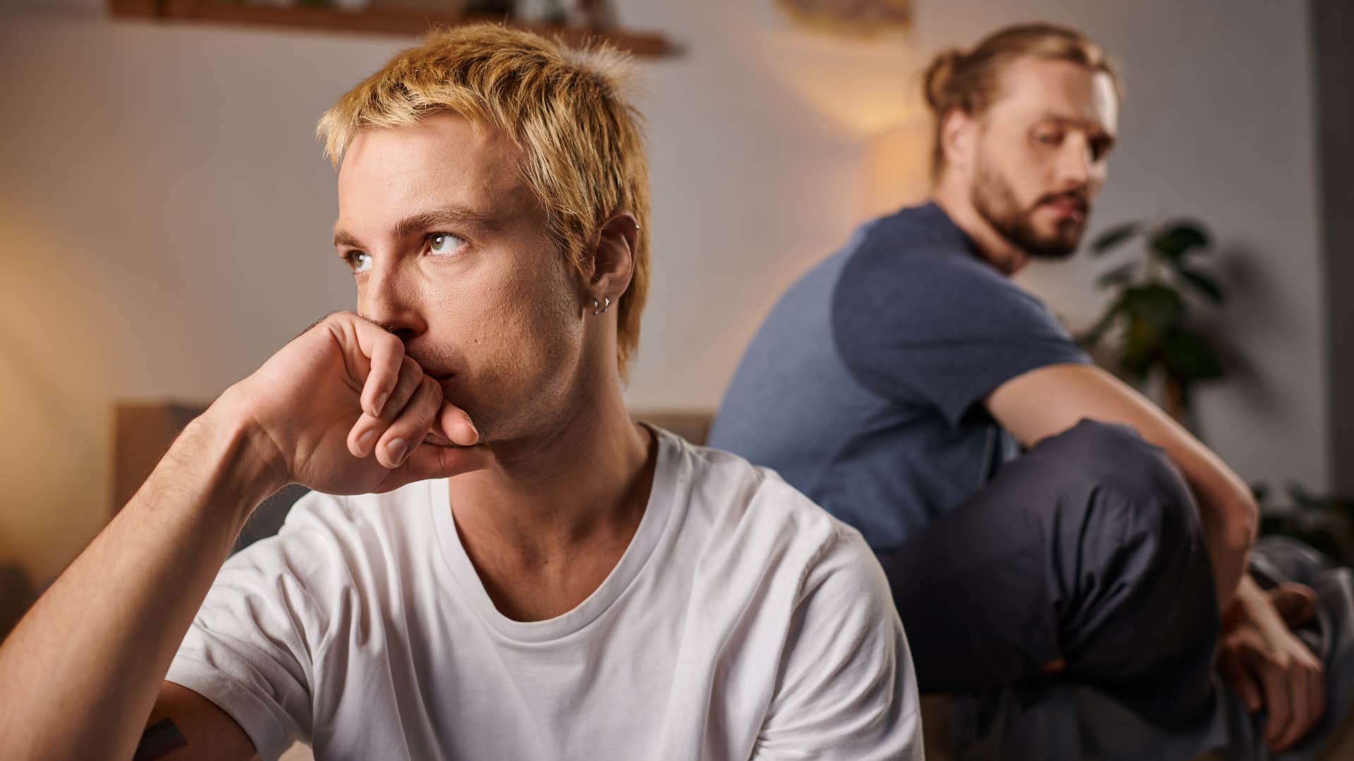 Man looking offended and upset in front of his partner.