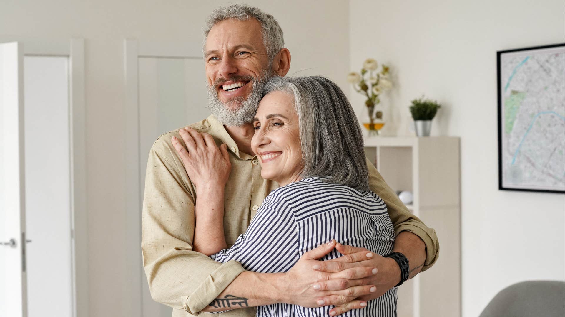 Happy older couple hugging.