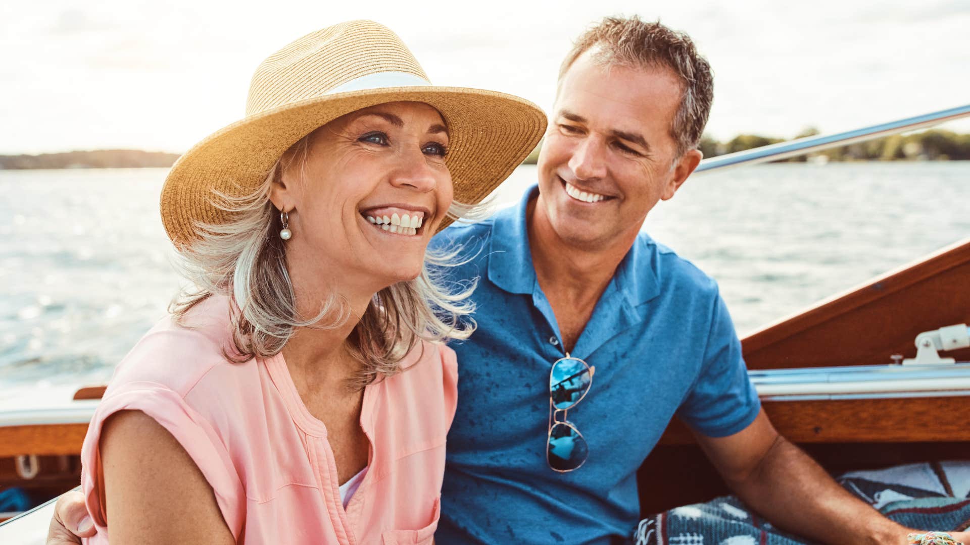 Happy couple smiling on a boat together.