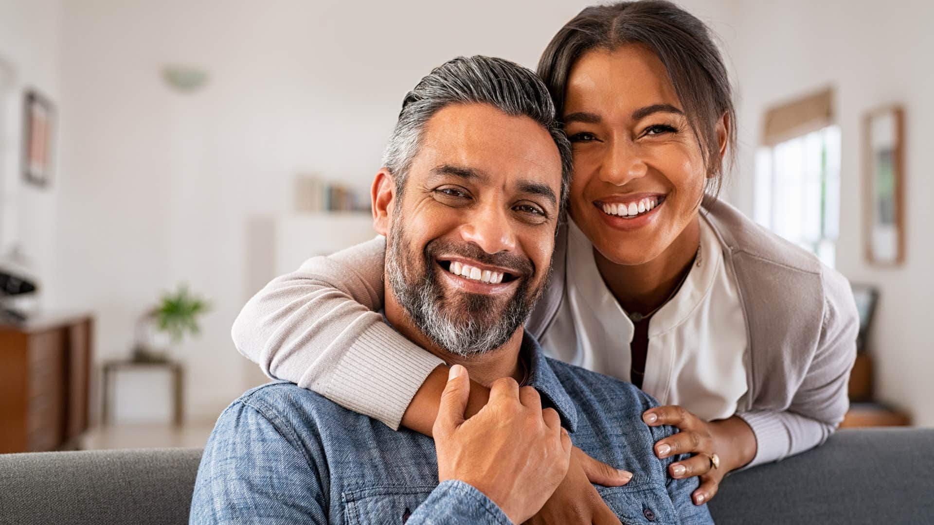 Happy older couple smiling and hugging.