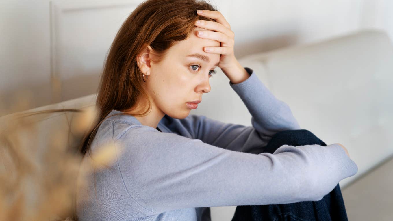 Anxious woman feeling tense in body.