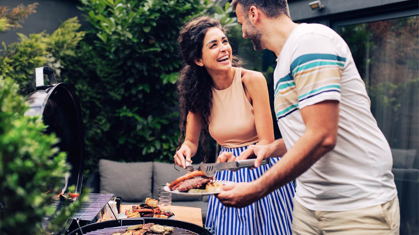 Woman being kind to her husband, making him lunch on the grill. 