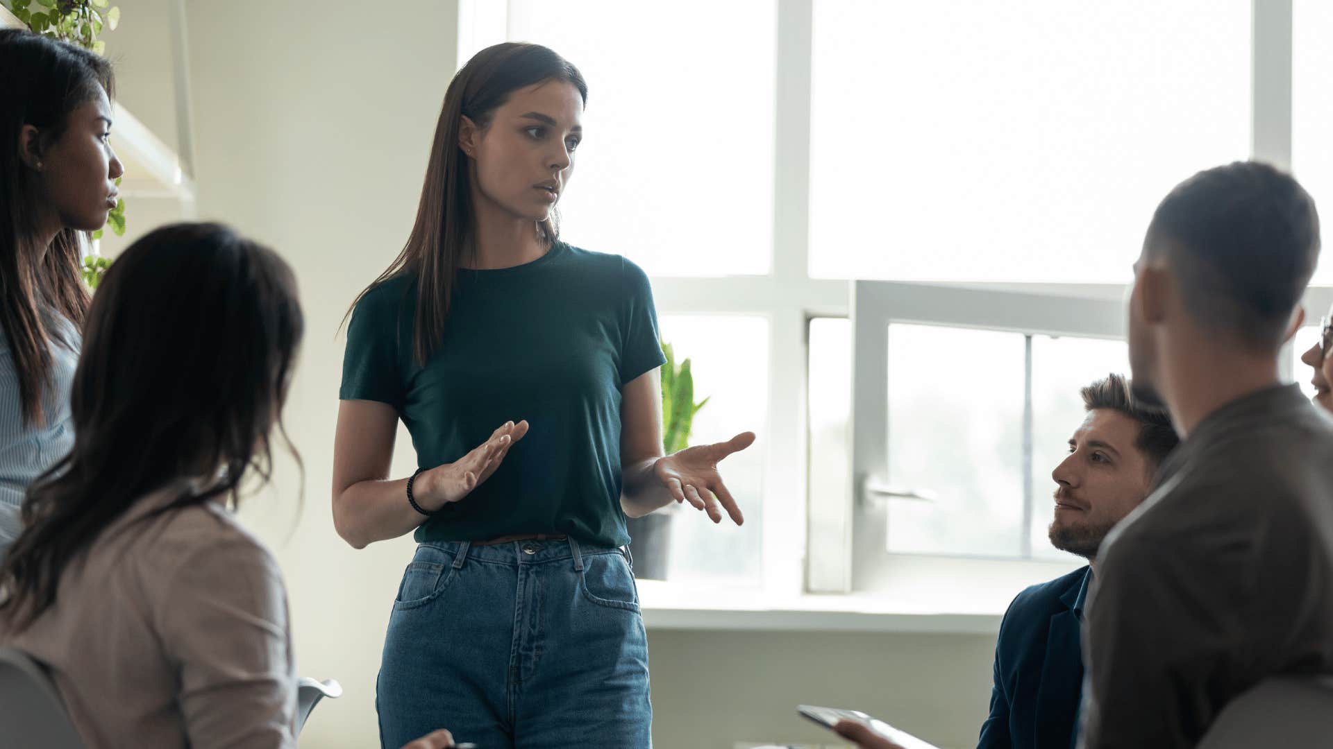 woman explaining something to coworkers