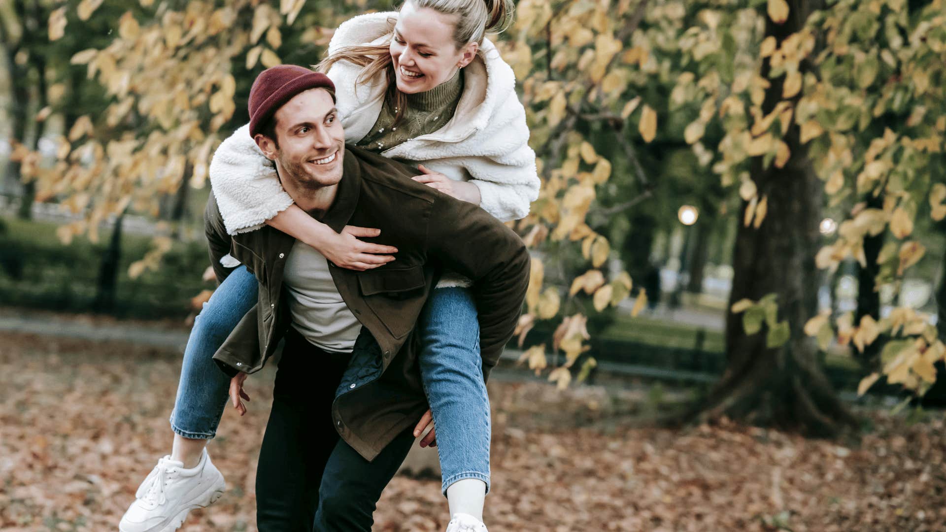 woman smiling while on man's back