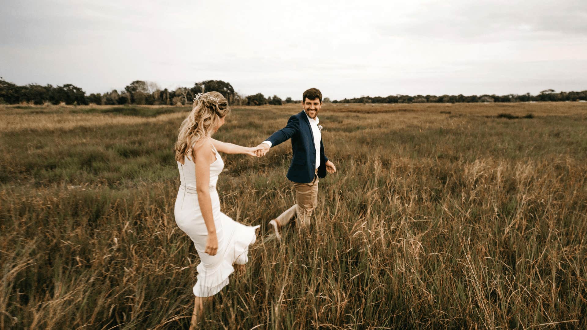 couple running through a field