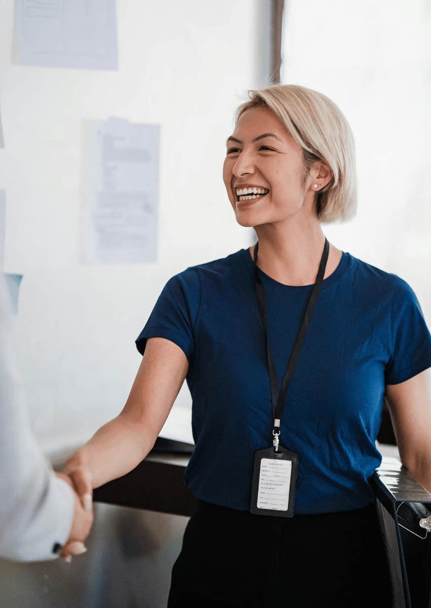 smiling professional woman shaking hands with a man