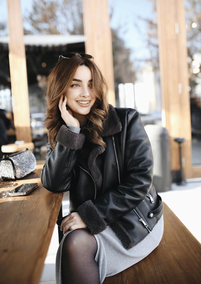 smiling young woman wearing a leather jacket