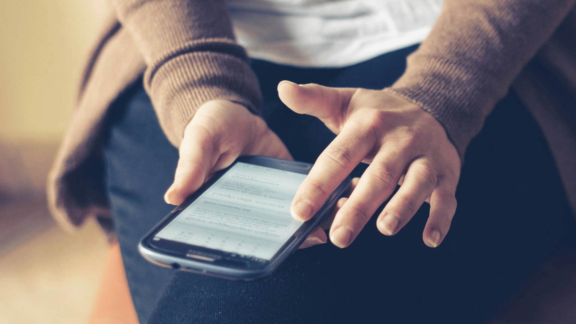 person sitting while on their phone