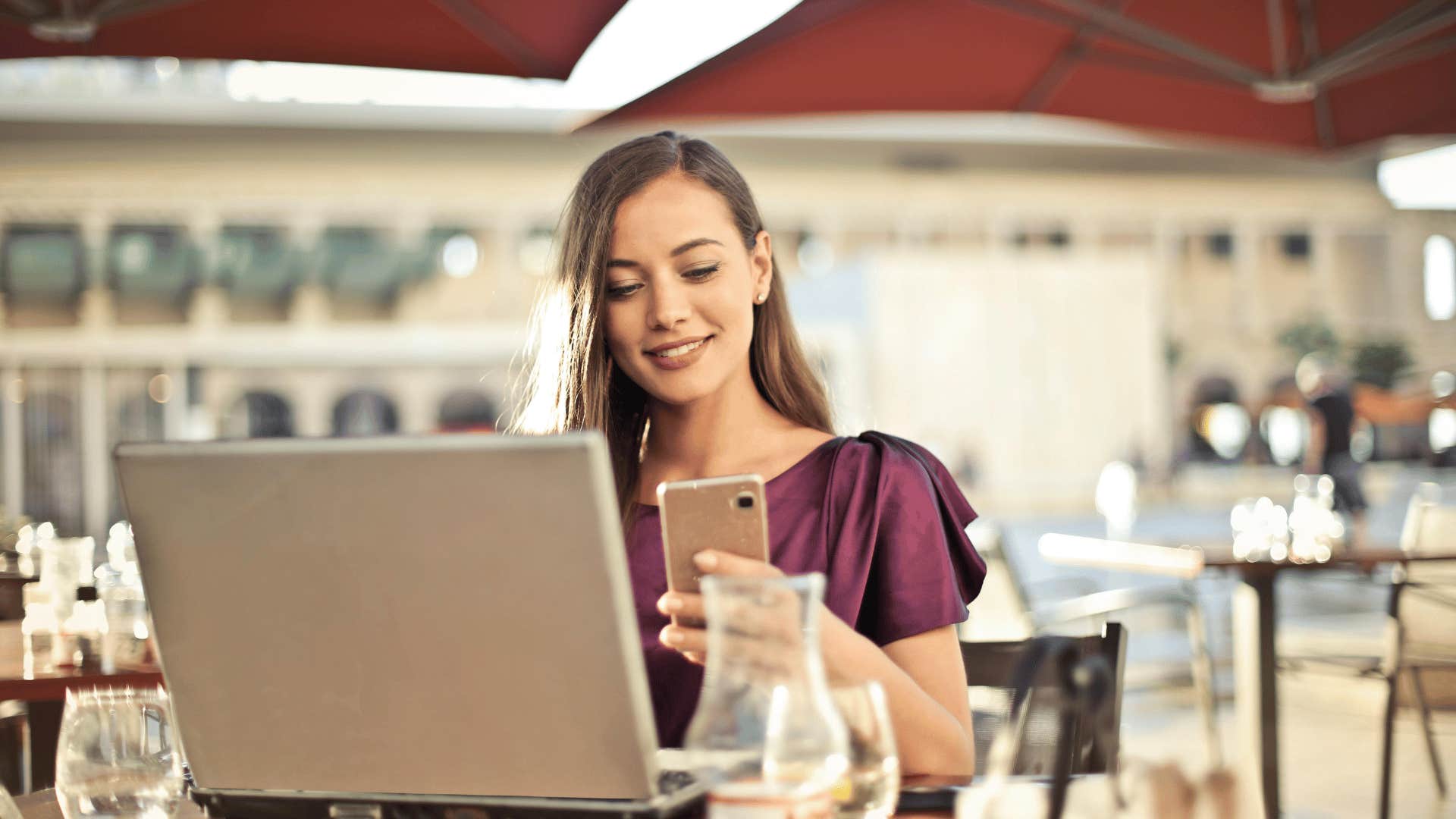 woman on phone and laptop