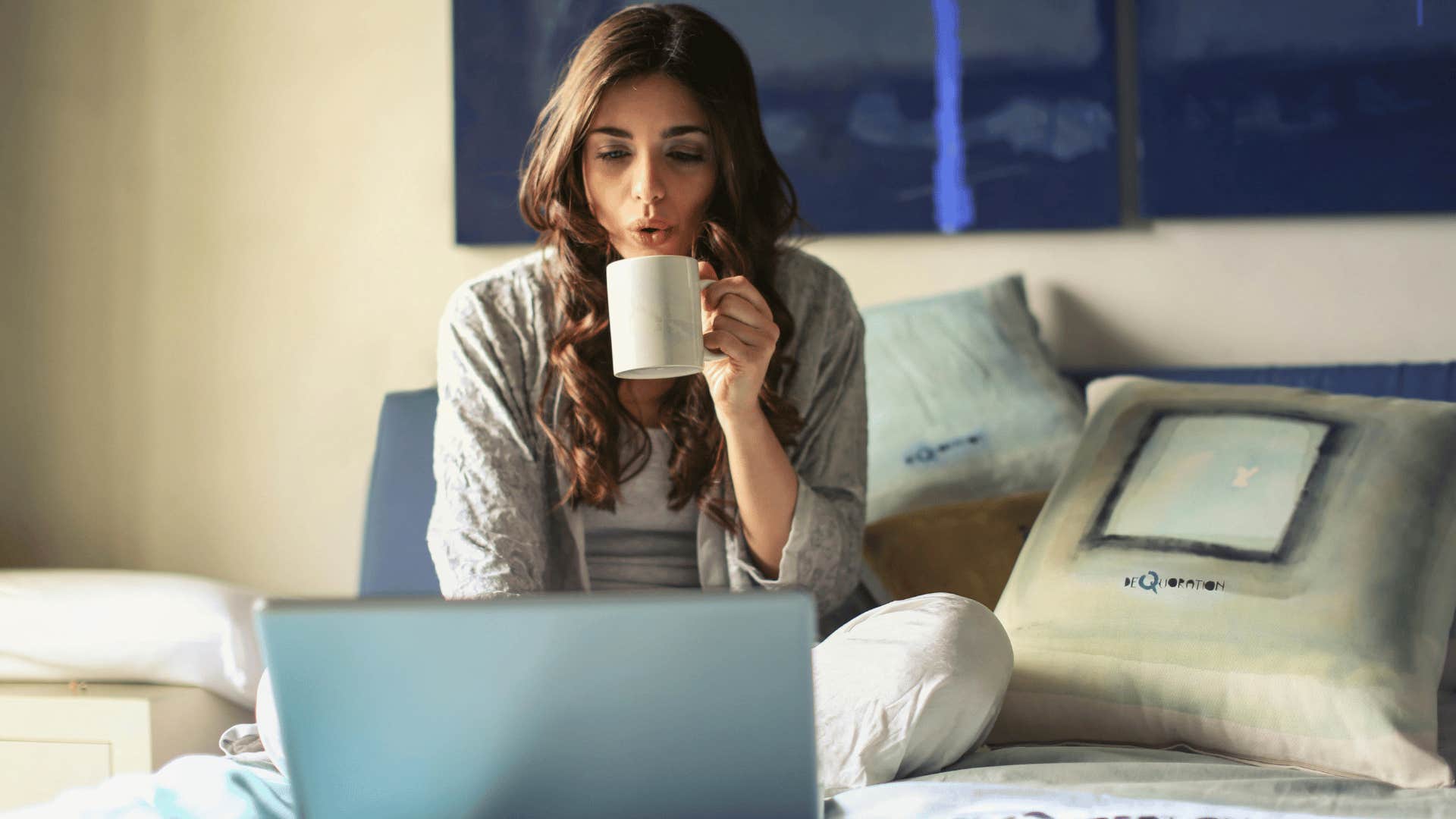 woman on laptop in bed