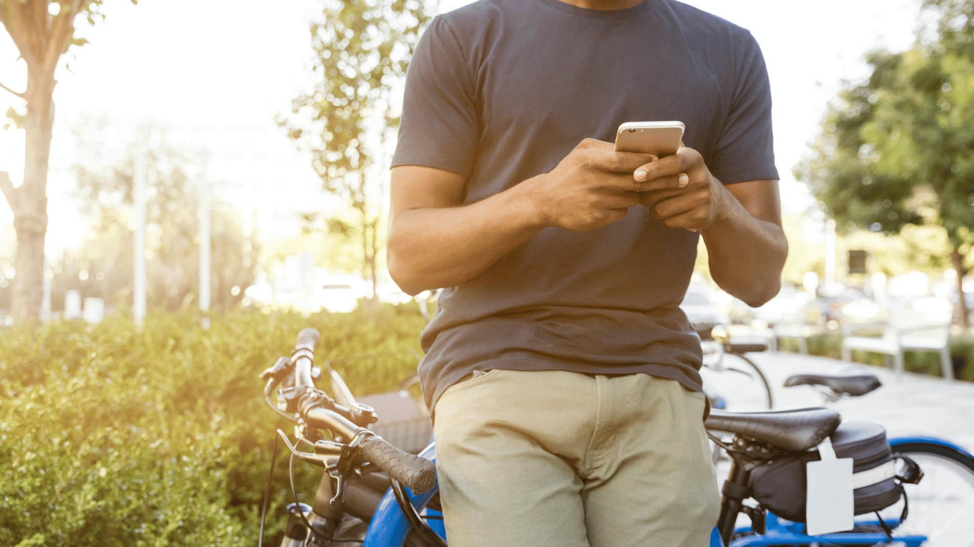 man on phone next to bike