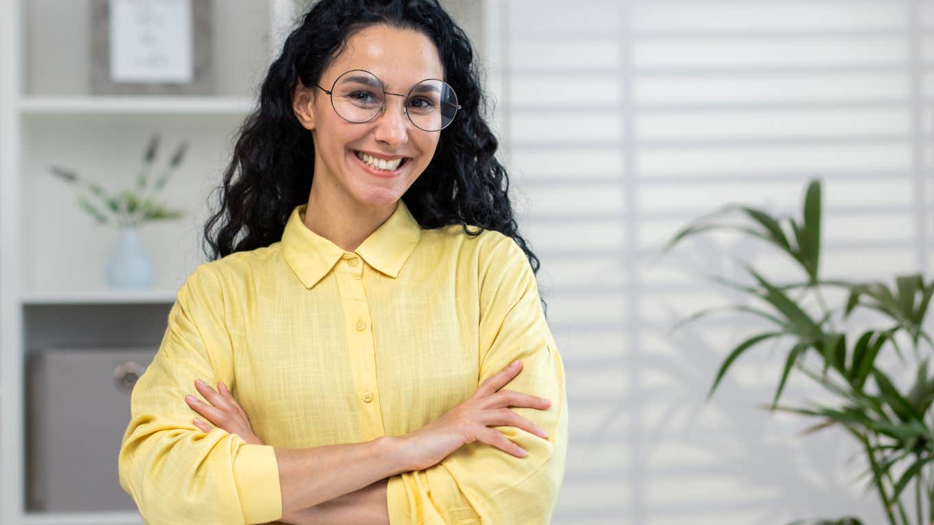 happy, professional woman standing in office