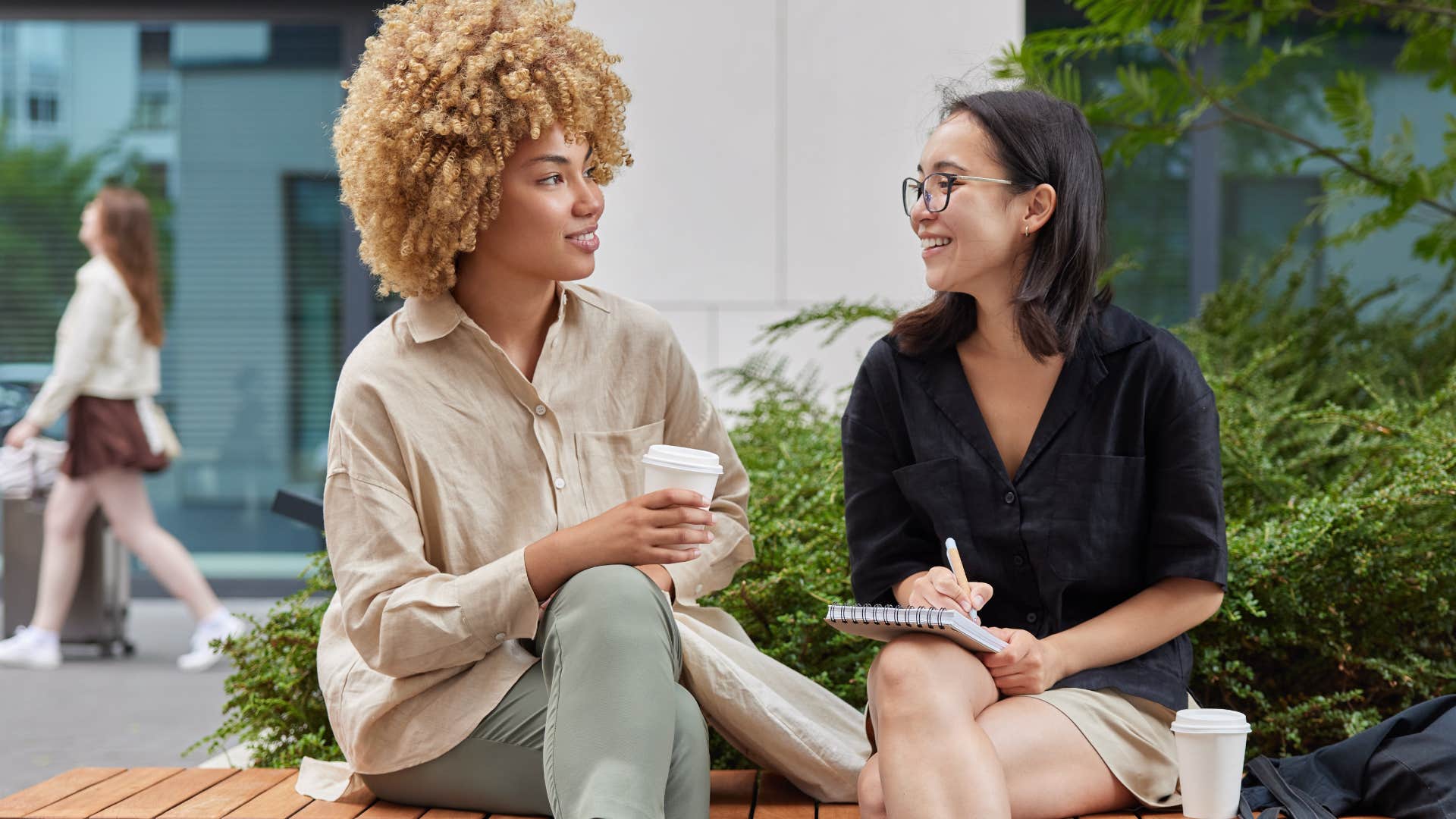 Two women smiling and talking to each other.