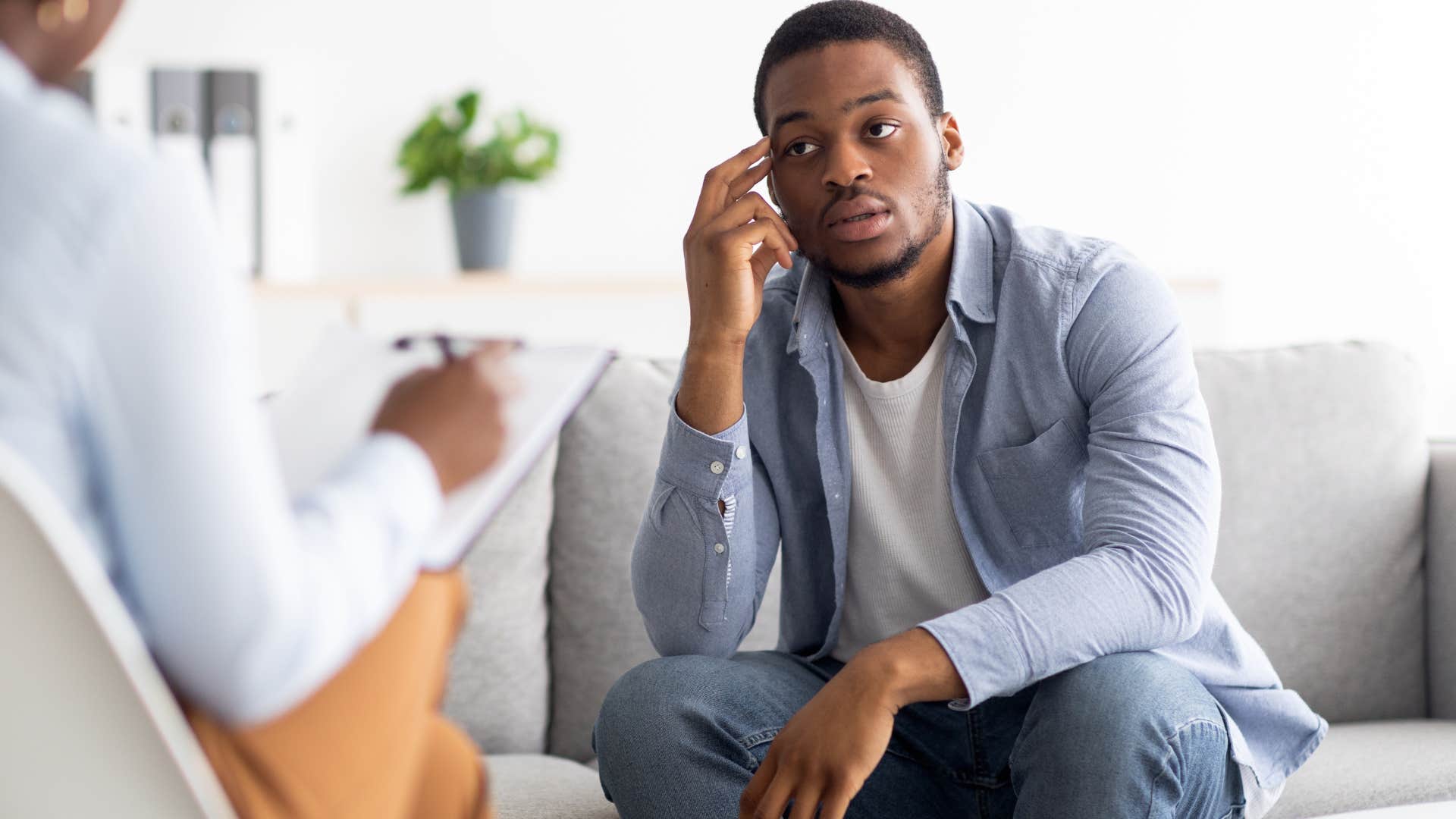 Man looking upset sitting across from his therapist.