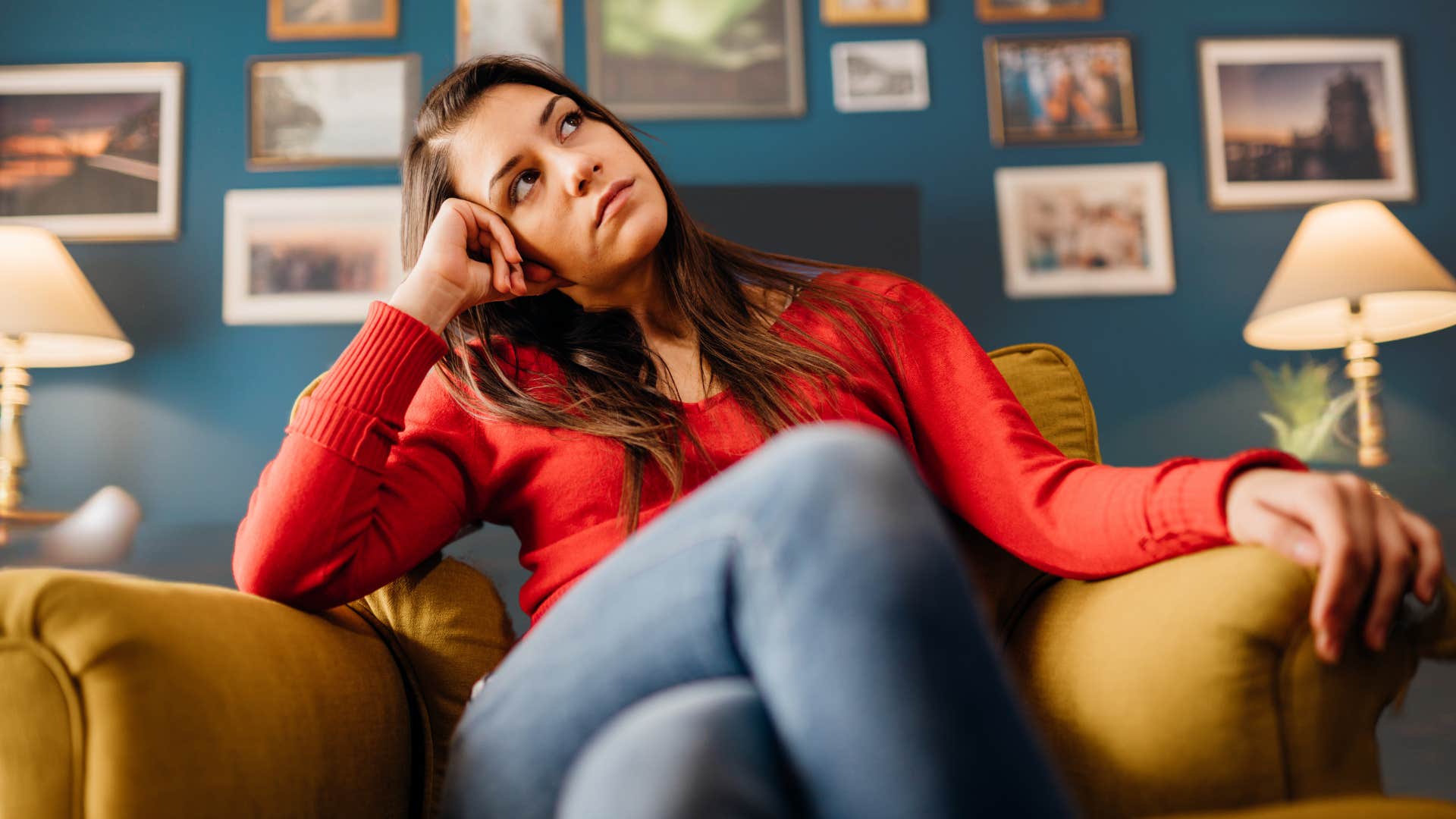 Woman looking frustrating thinking in her living room.