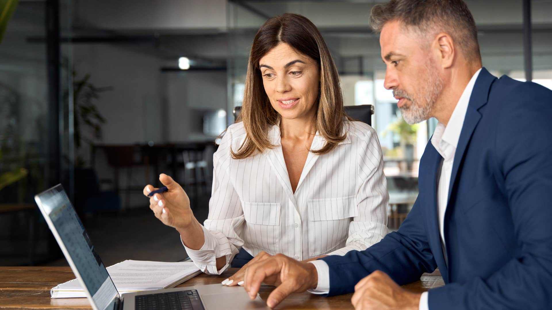 Woman talking to her boss in front of a laptop.