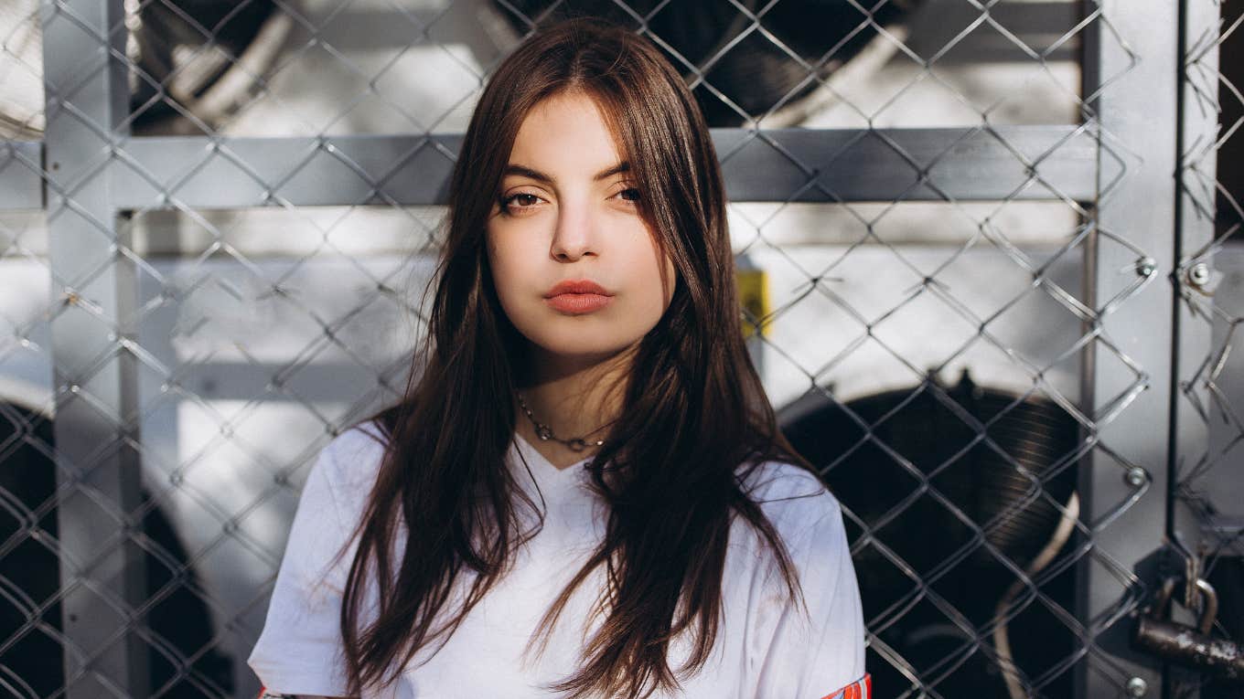 Portrait of young fashionable girl posing in the city