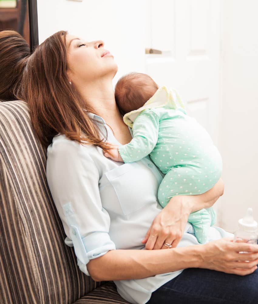 tired mom holding newborn