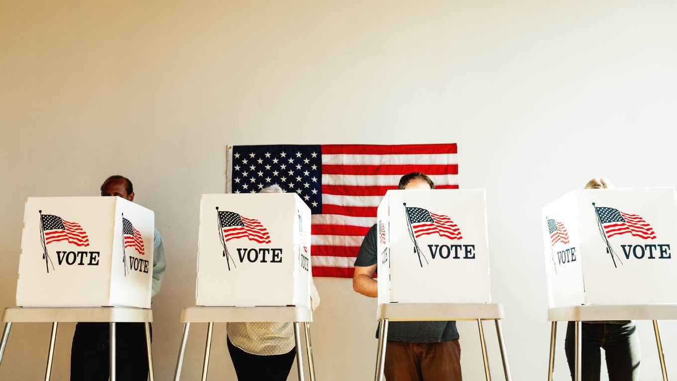 four people voting in booths