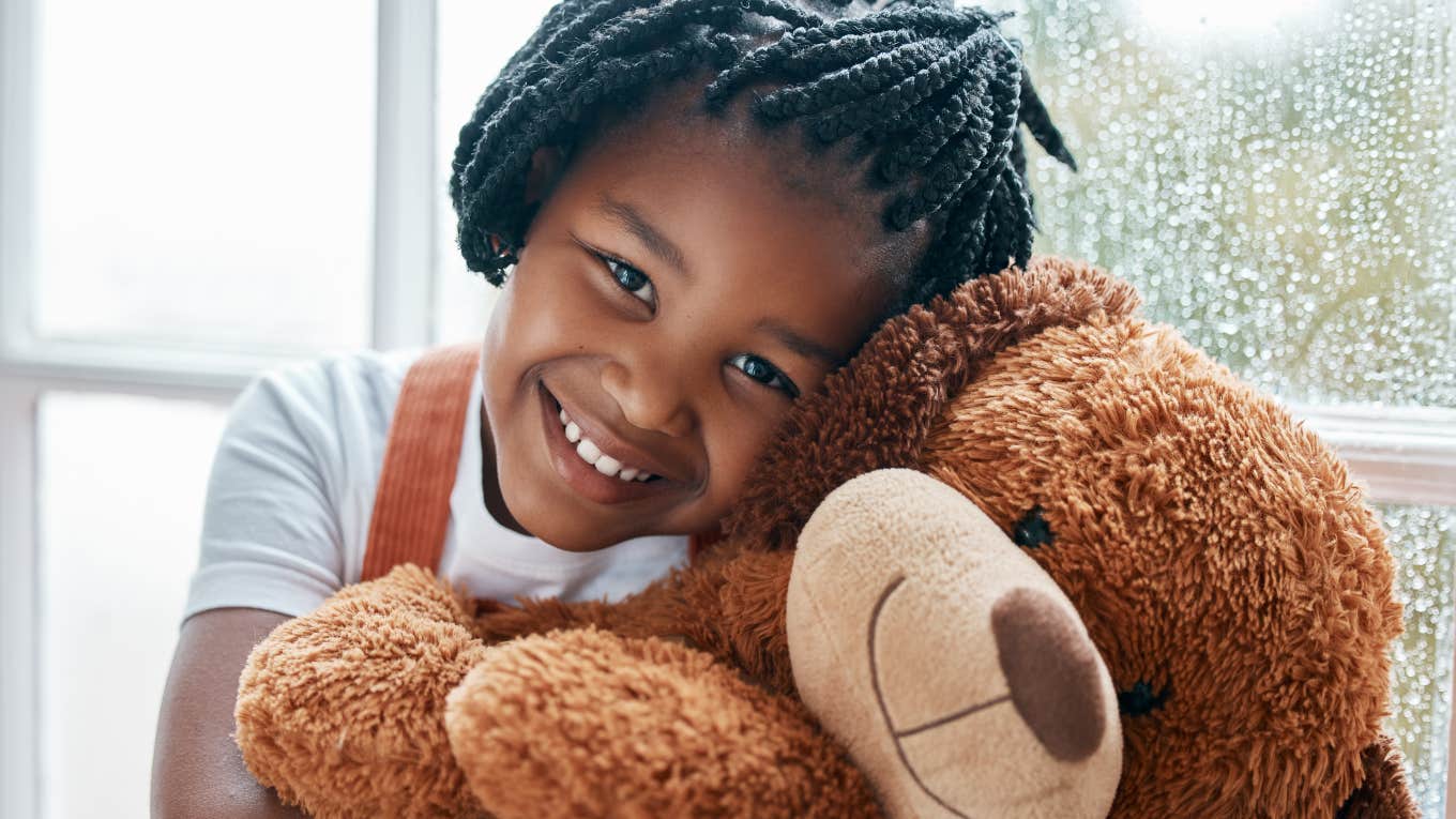 little girl hugging a large stuffed bear