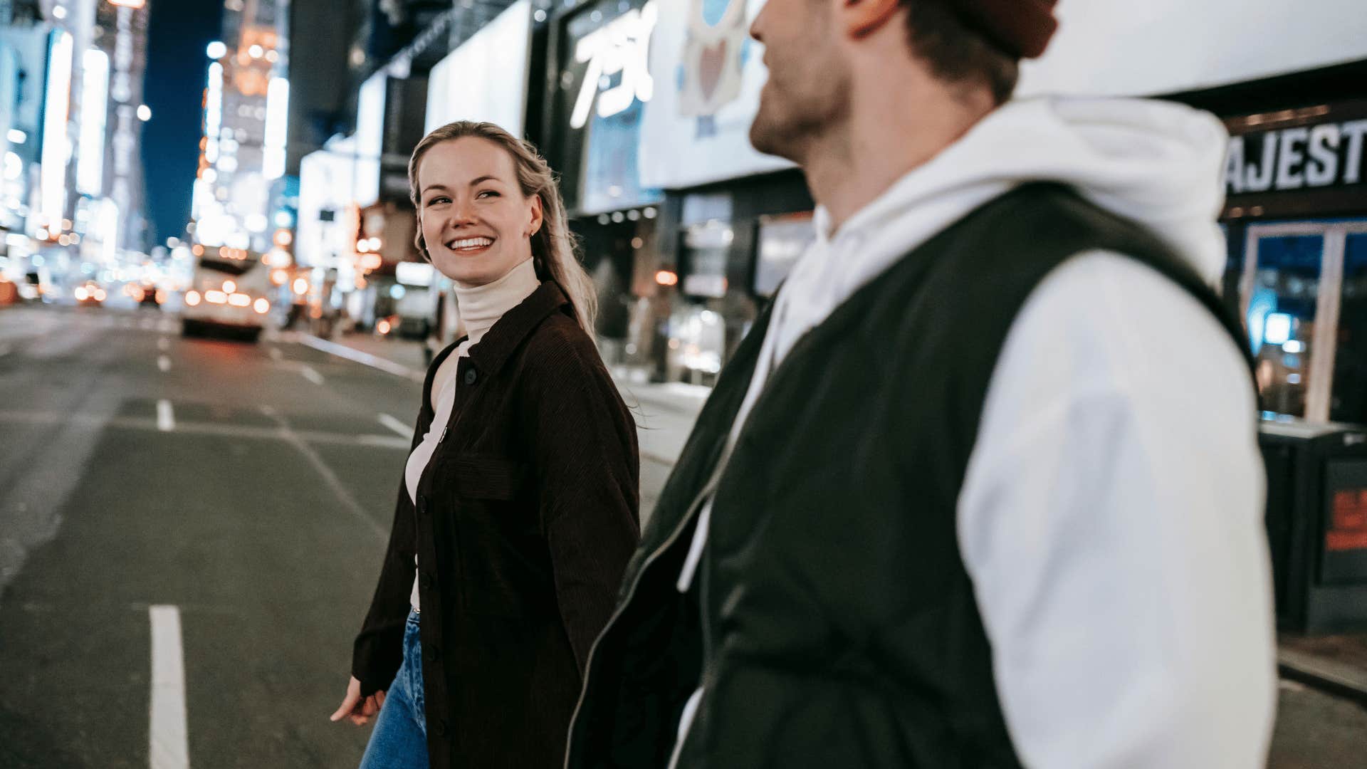 couple holding hands walking