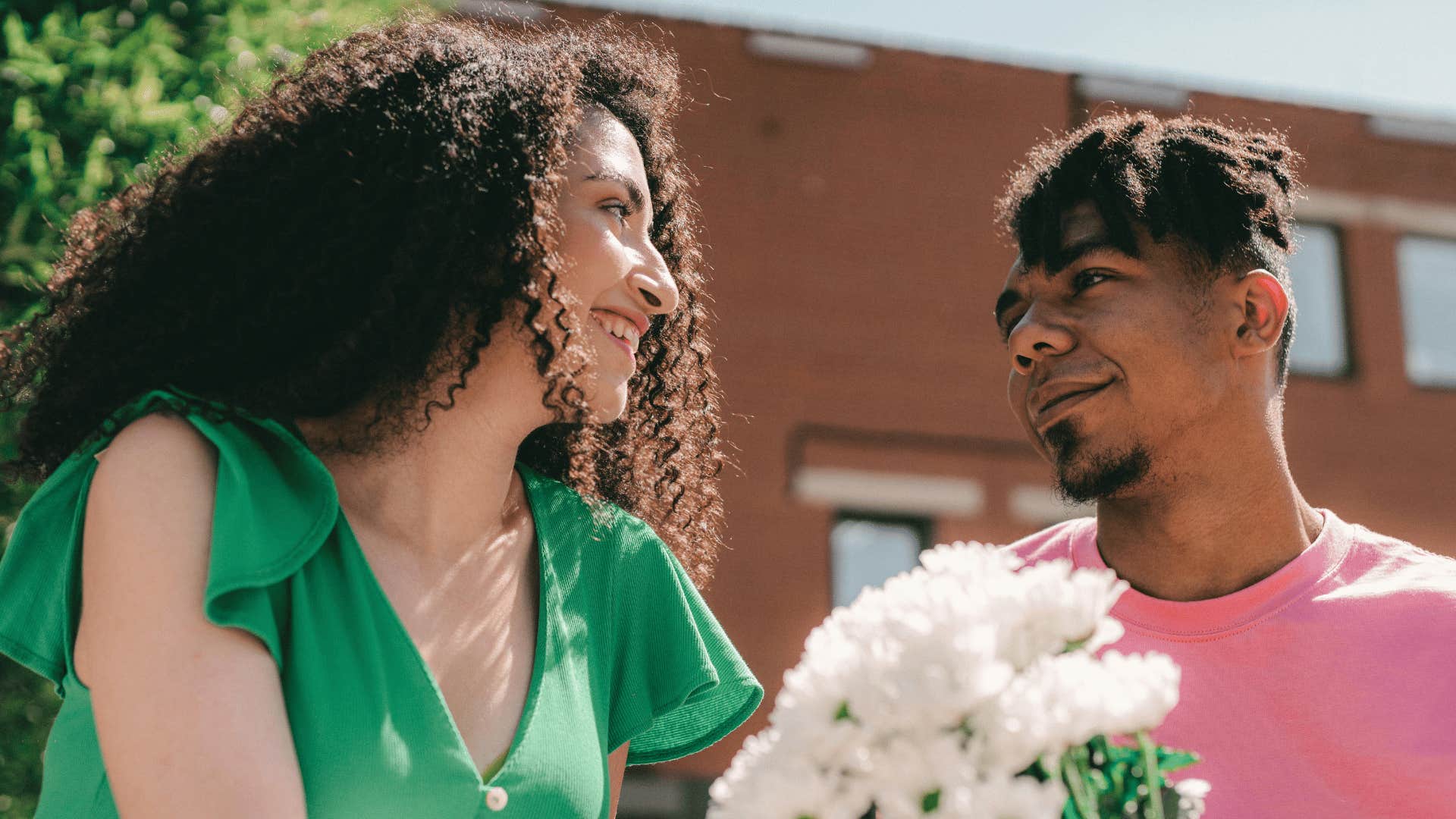 man giving woman flowers