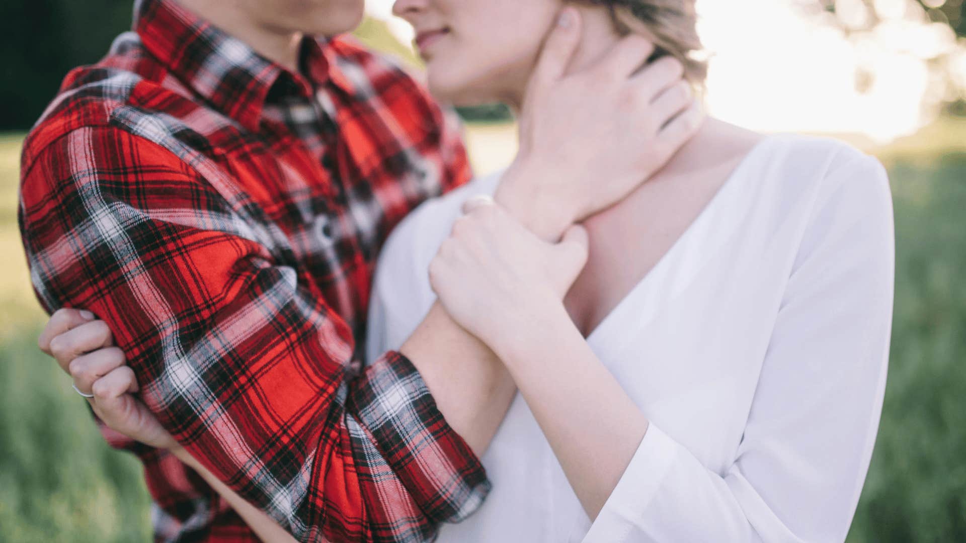 man holding woman's face