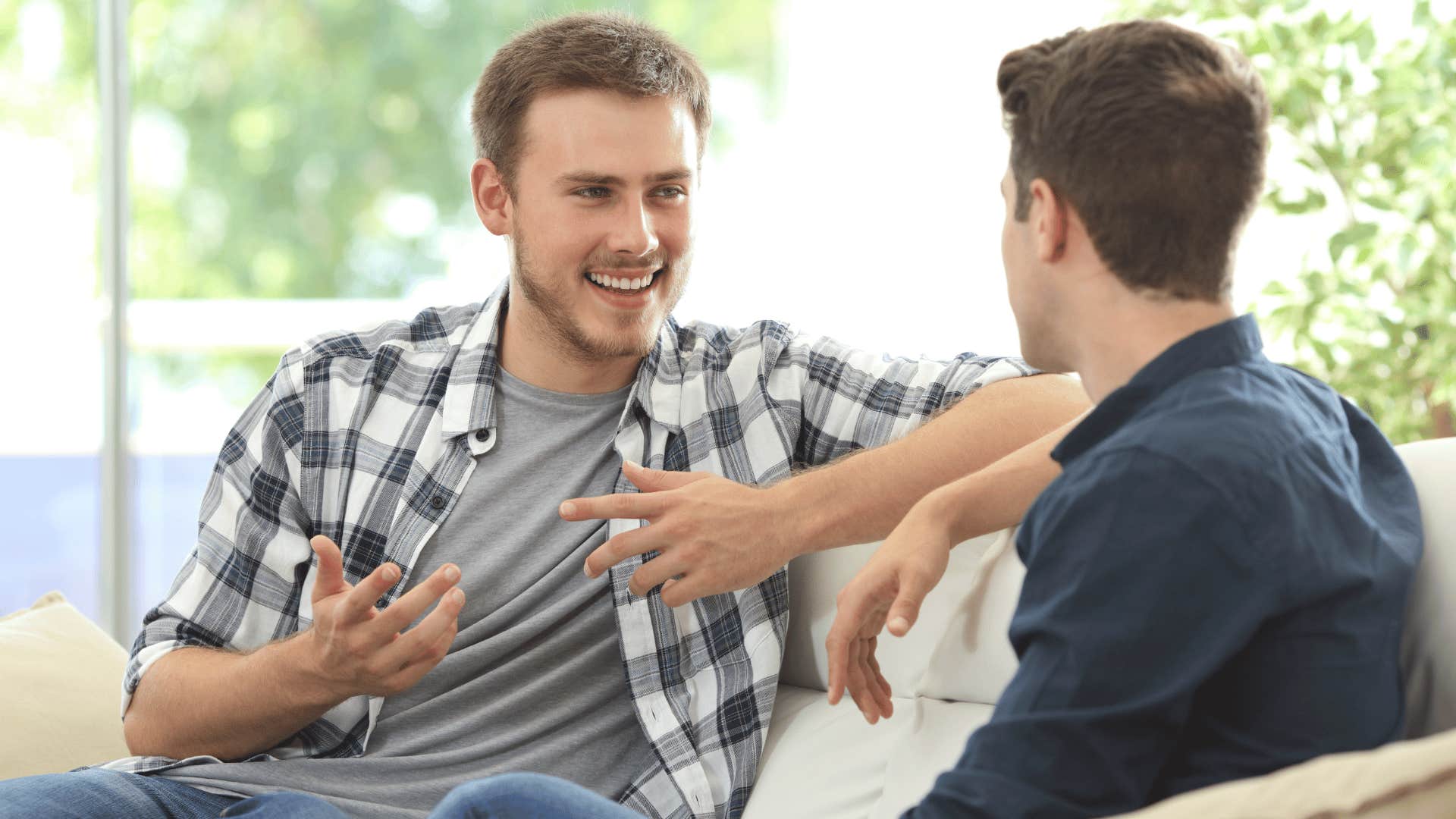 two men chatting on the couch