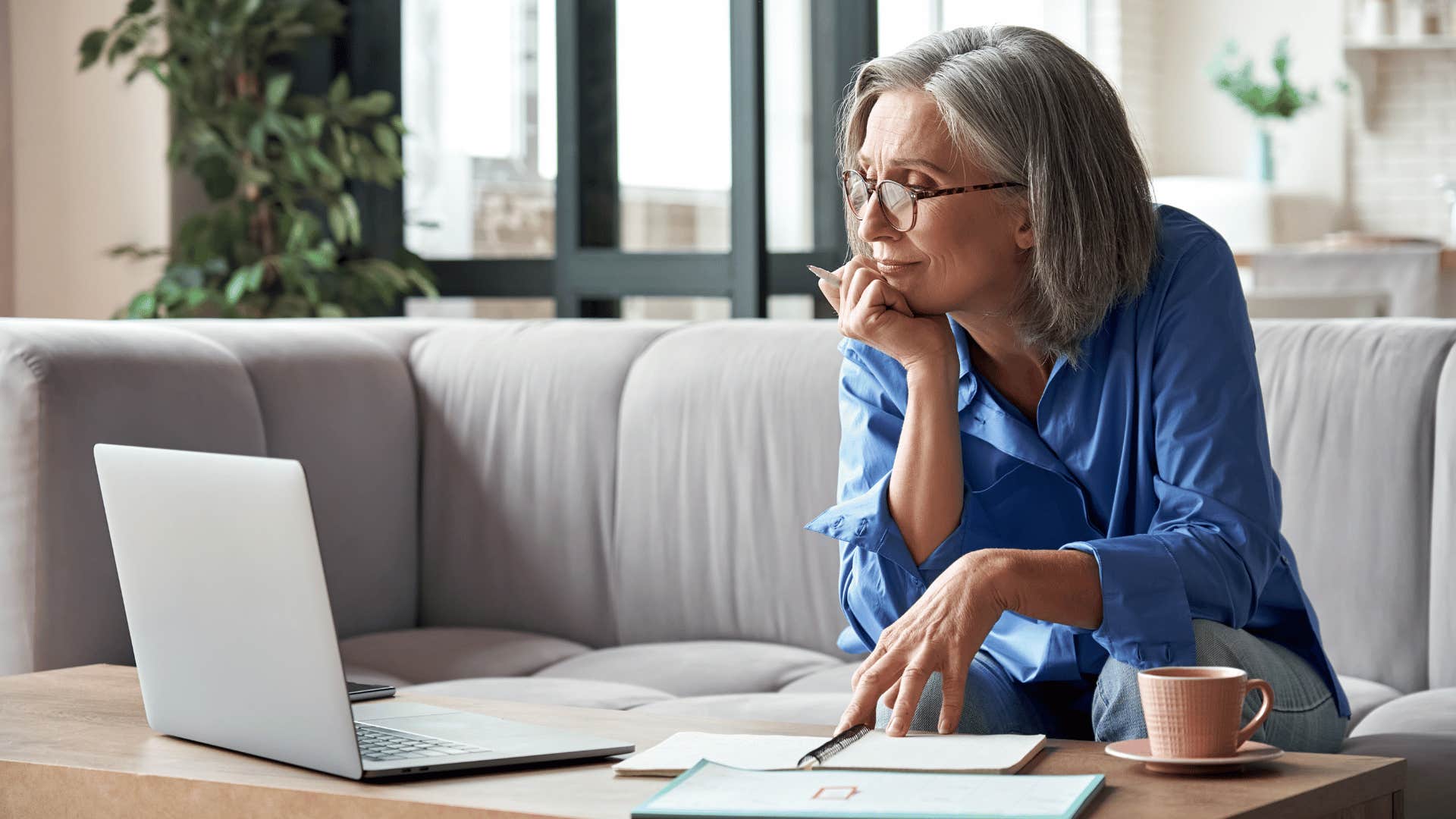 woman looking at her laptop and working