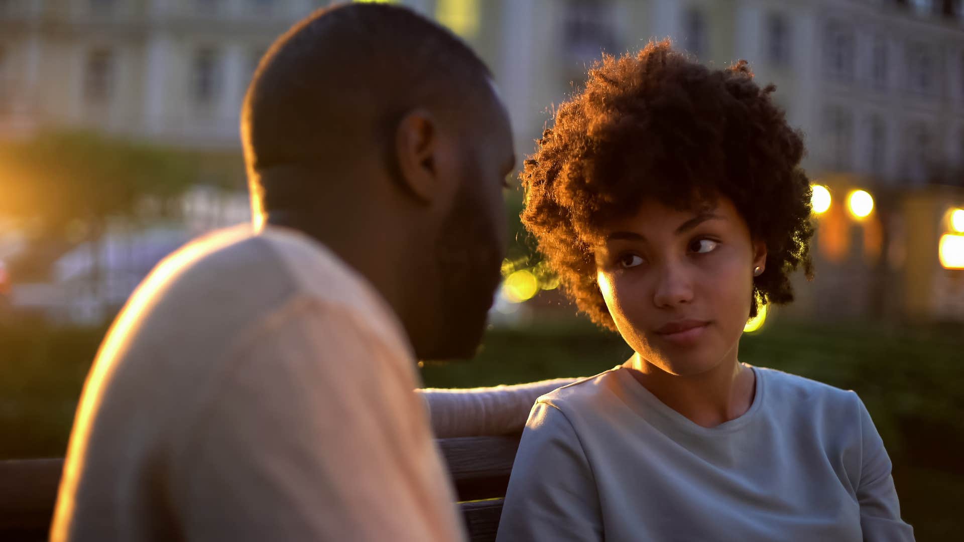 Woman looking skeptical staring at a man.