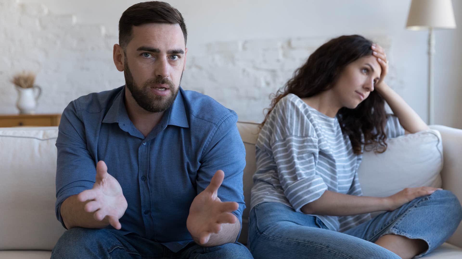 Man talking at the camera while a woman looks away next to him.