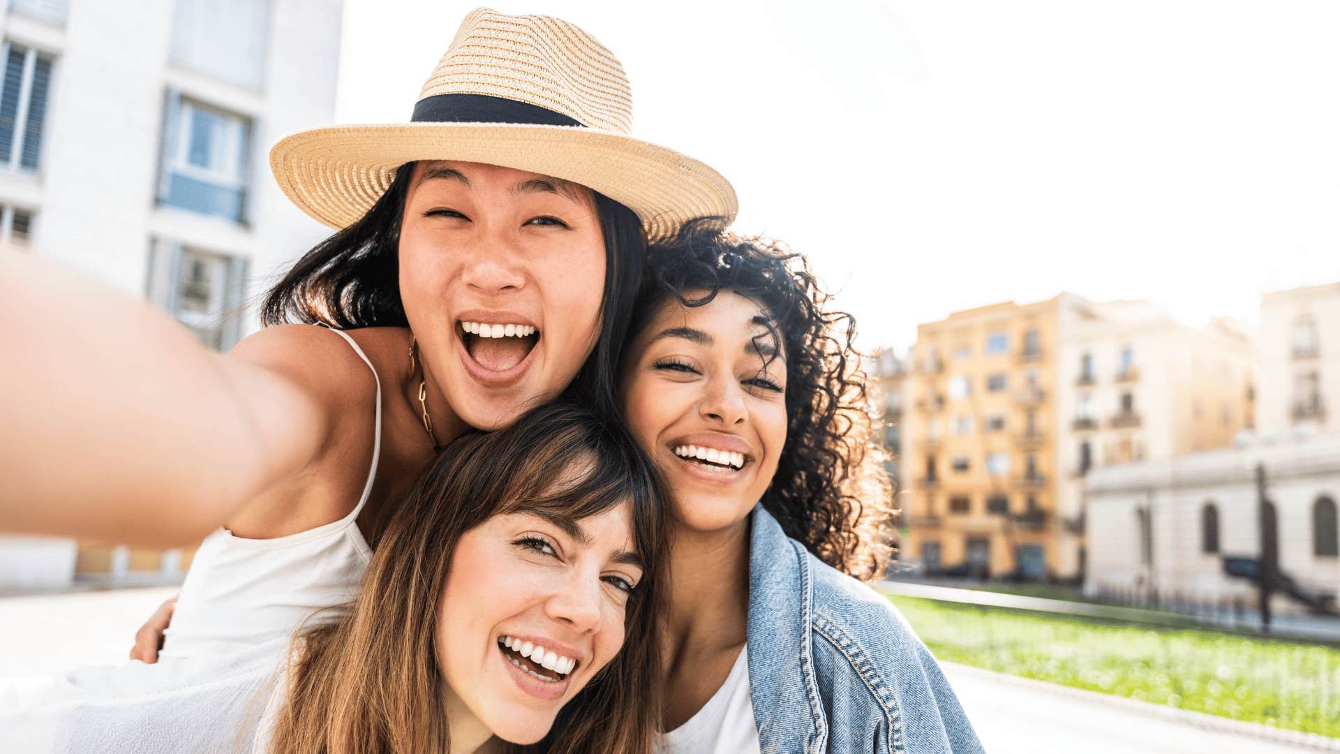 three female friends smiling 