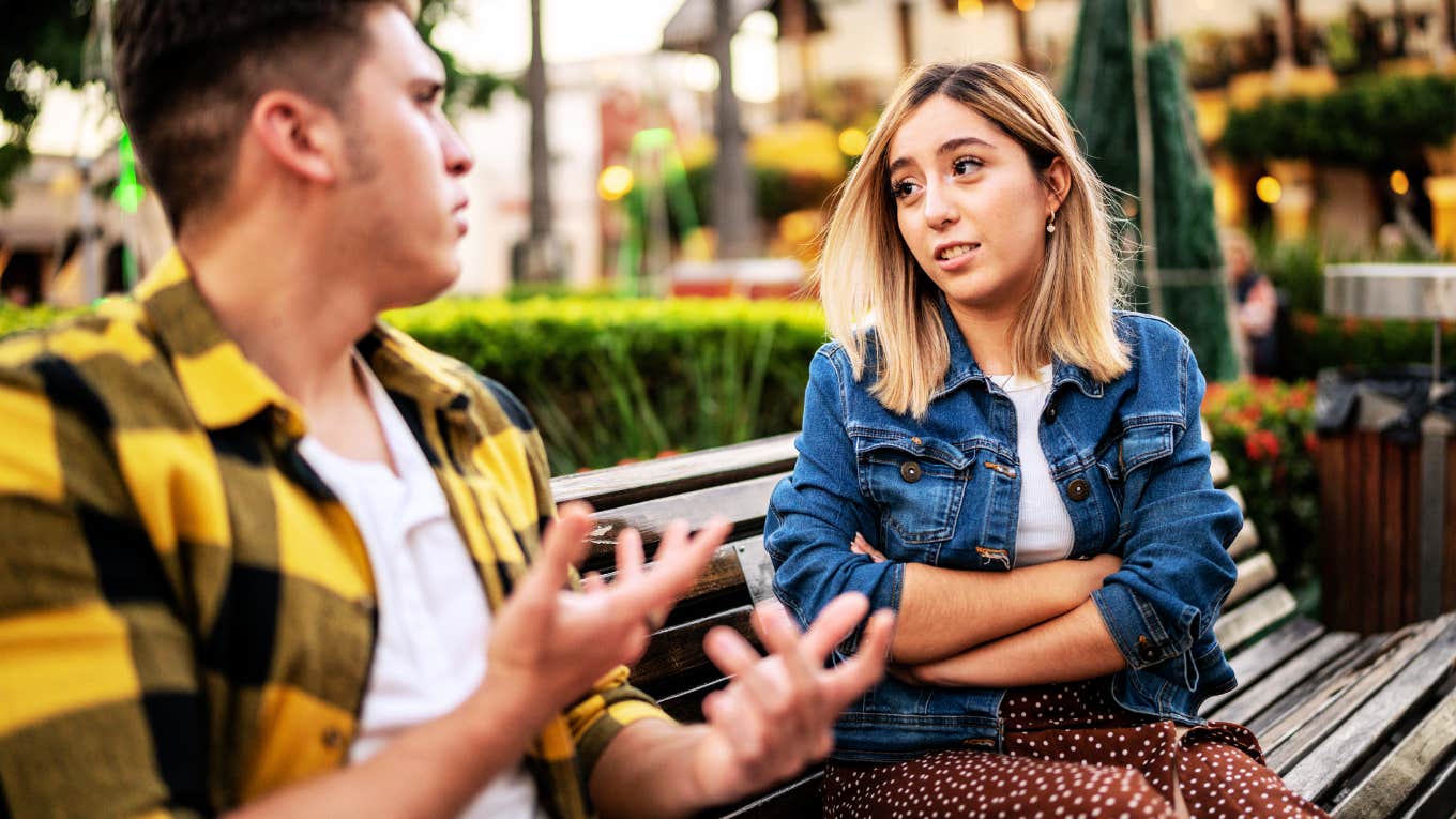 Woman looking suspiciously at man who is cheating. 