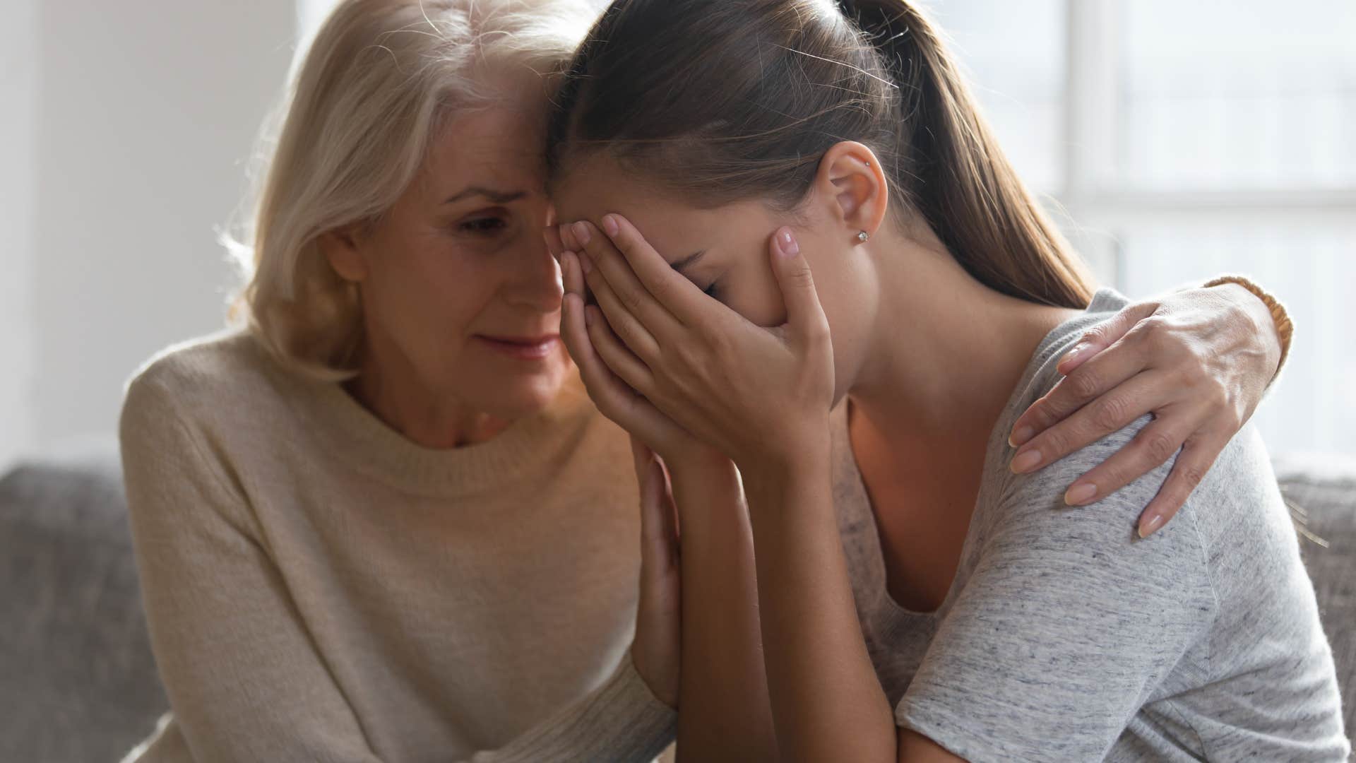 Woman looking upset staring at her mother.