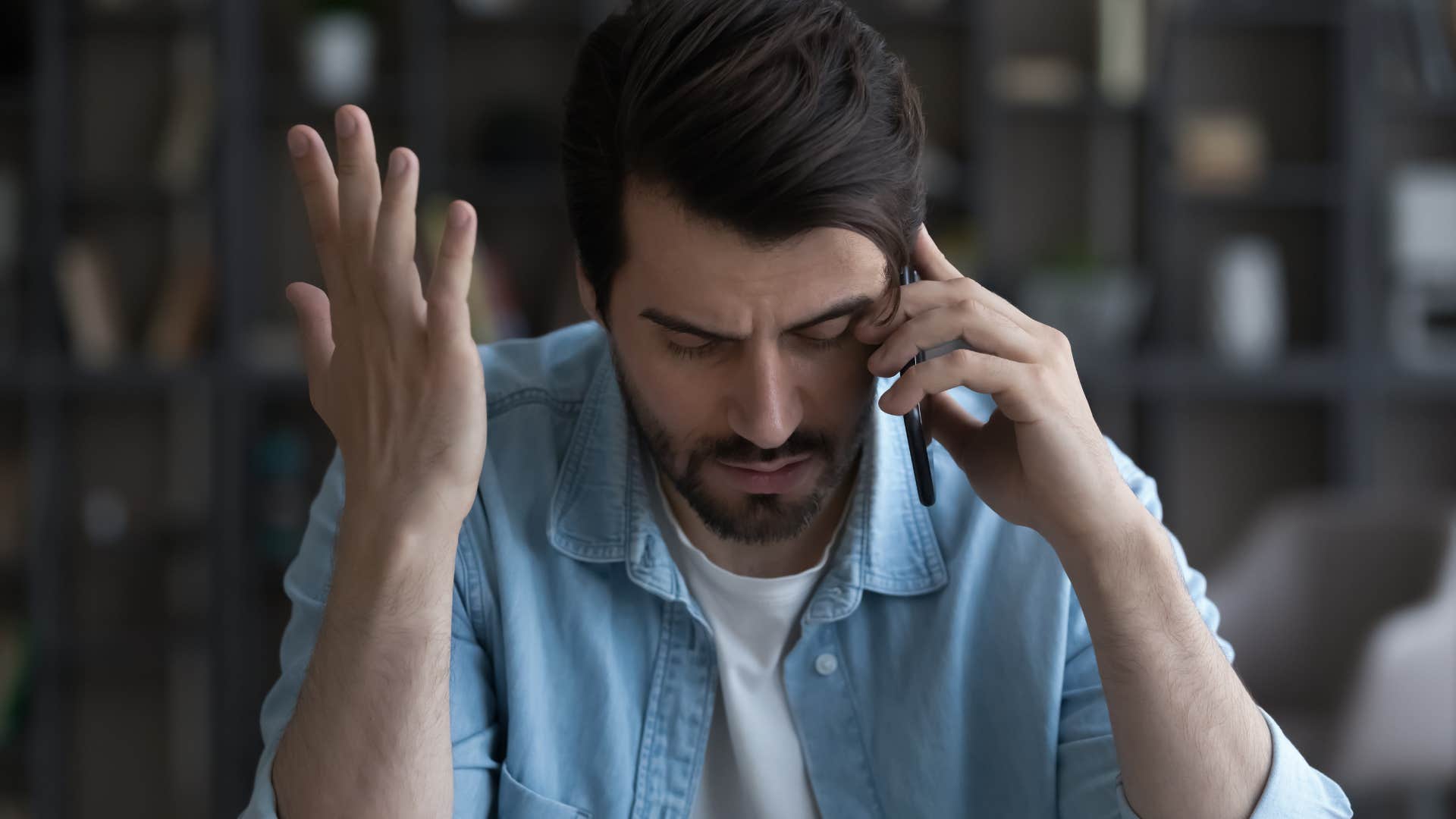 Man looking upset talking on his cell phone.