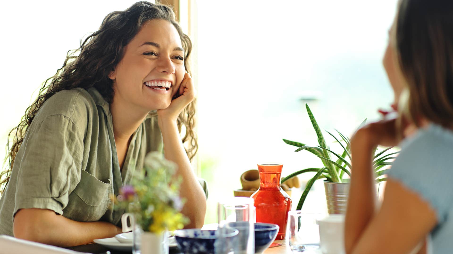 Woman smiling while talking to a friend.