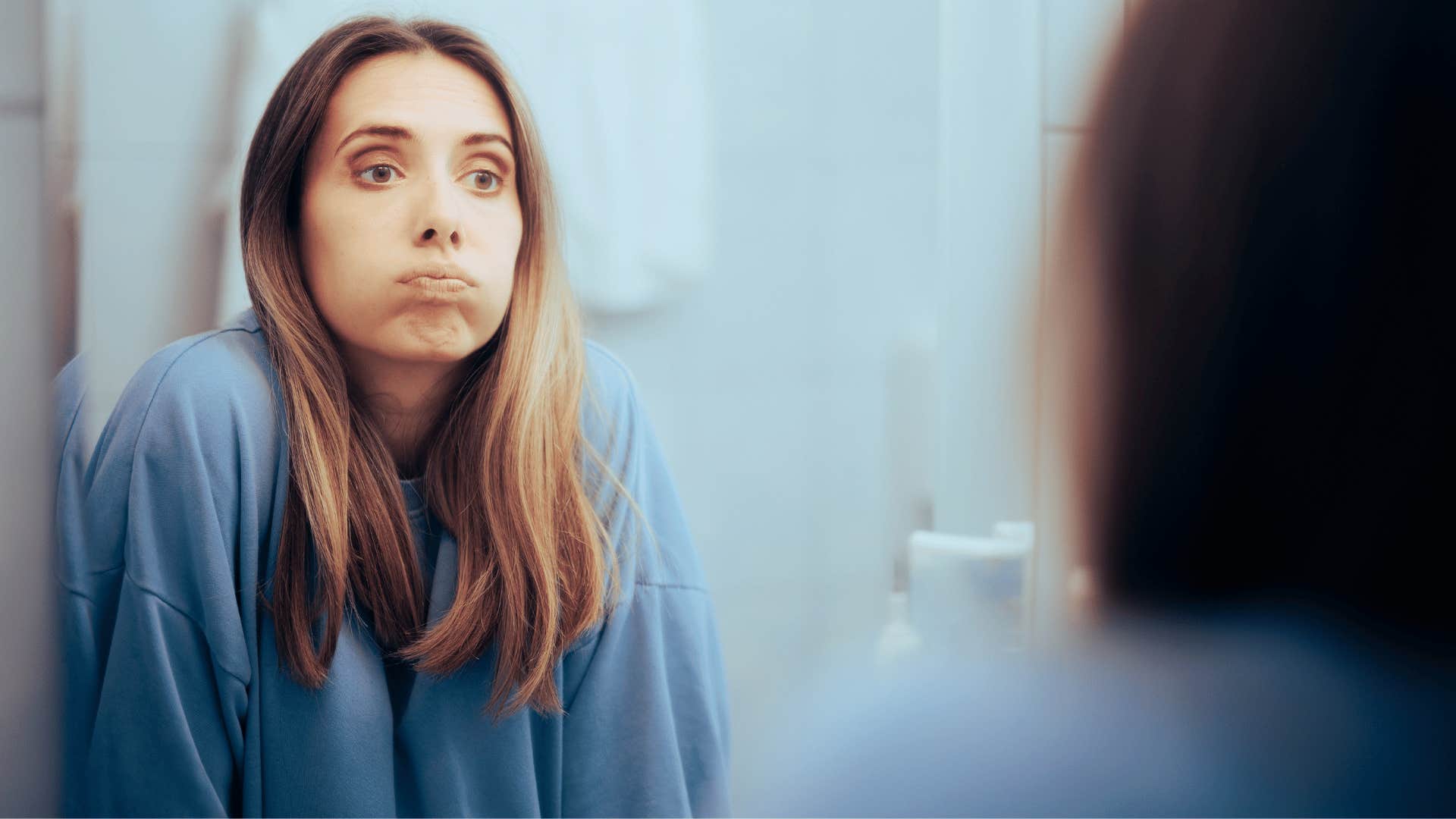 Woman looks in mirror to take personal responsibility