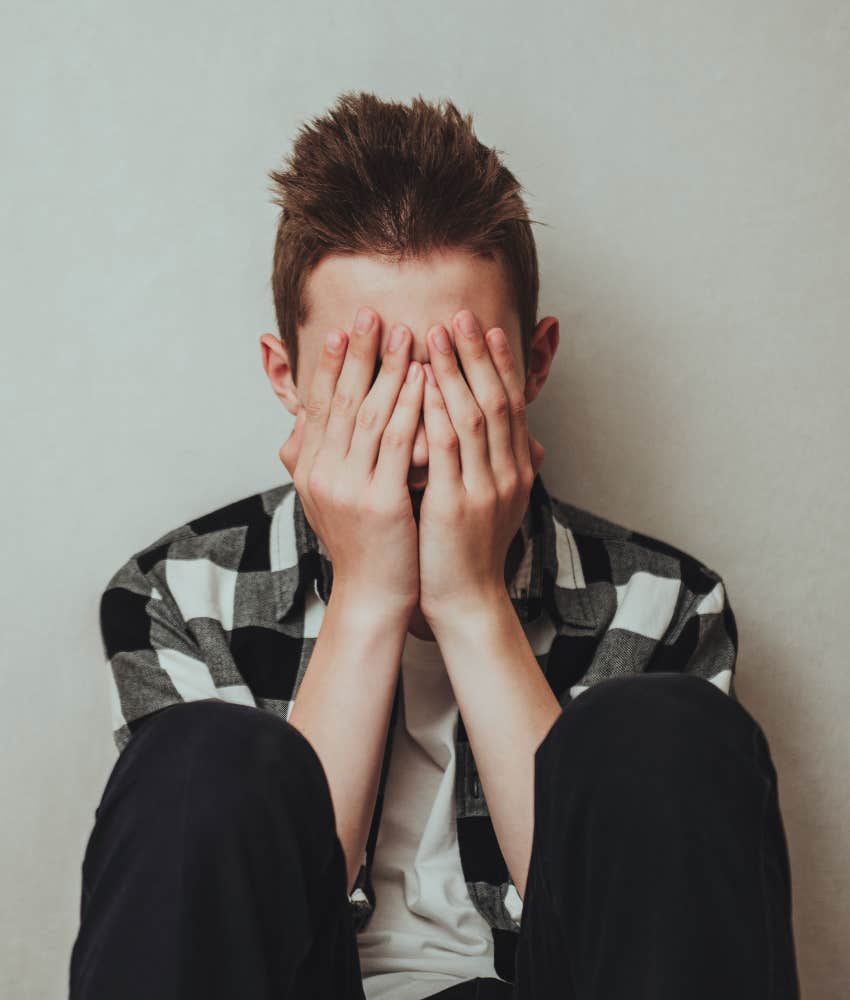 Teen boy crying after getting caught bullying classmate